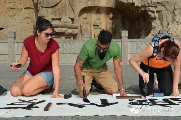 Иностранные студенты изучают каллиграфию в Пещерах Лунмэнь