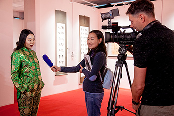 Various reporters interview exhibitors 